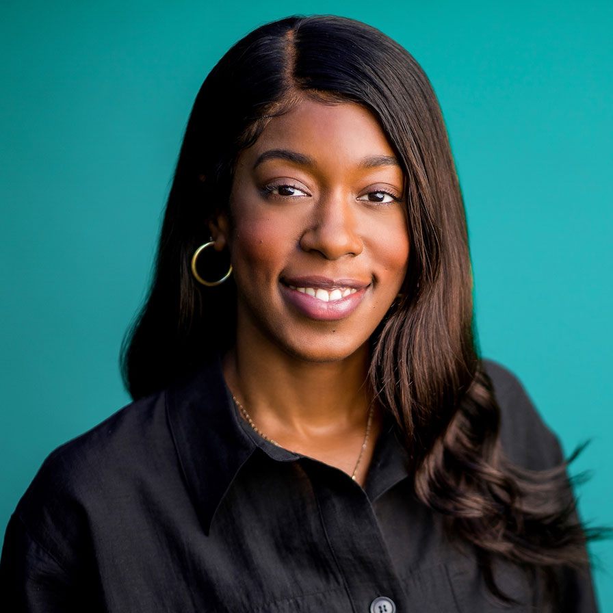 Courtney Chase headshot, smiling in front of a greenish background.
