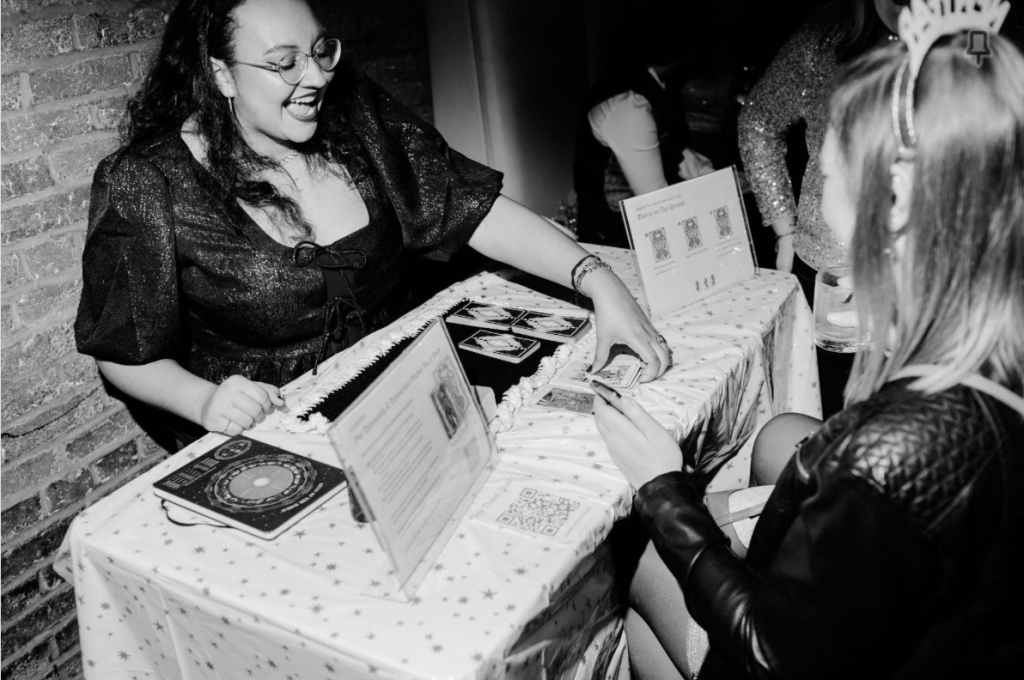 Logan doing crowdfunding tarot readings for DC Gay Girls+ New Queers Eve party